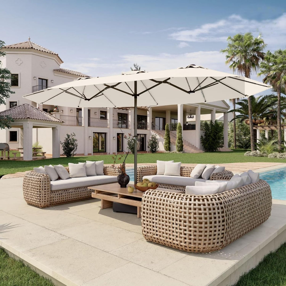 Patioslife Horizon Haven double-sided patio umbrella with base in cream, 4.6 x 2.7m, shading a poolside wicker sofa set in front of a luxury villa