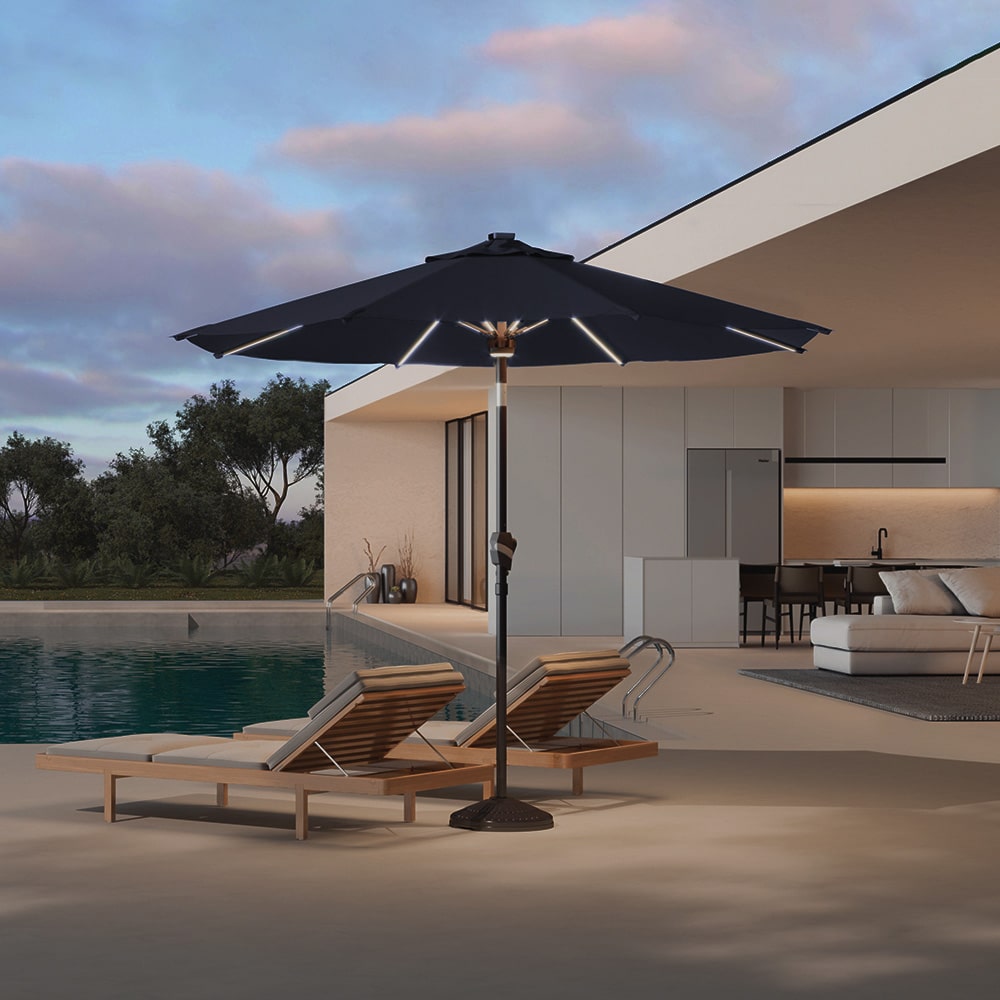 Patioslife Solara black market umbrella with soft rib lighting beside pool loungers at dusk