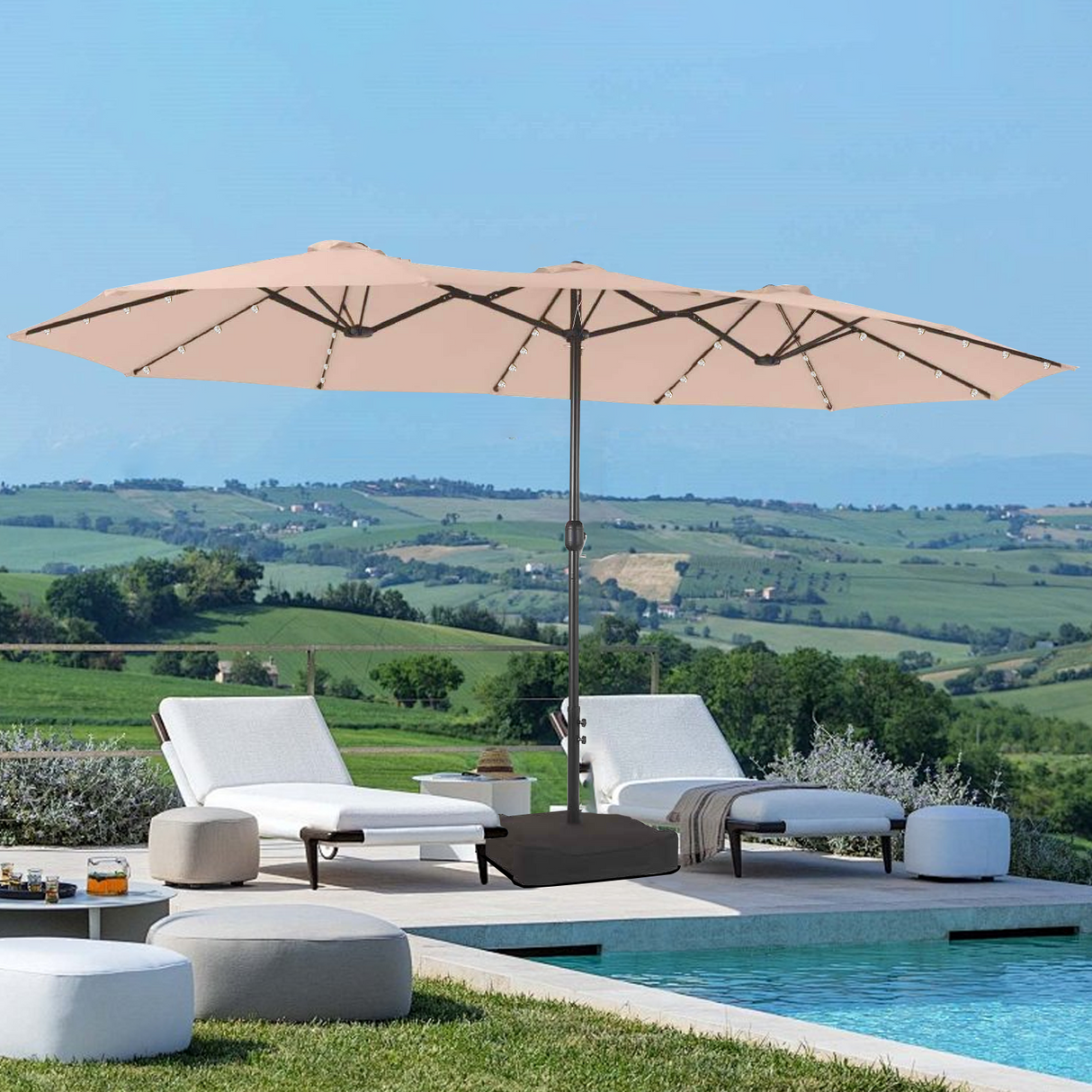 Patioslife Horizon Haven double-sided patio umbrella with base in tan, 4.6 x 2.7m,with LED lights shading a modern outdoor lounge near the sea