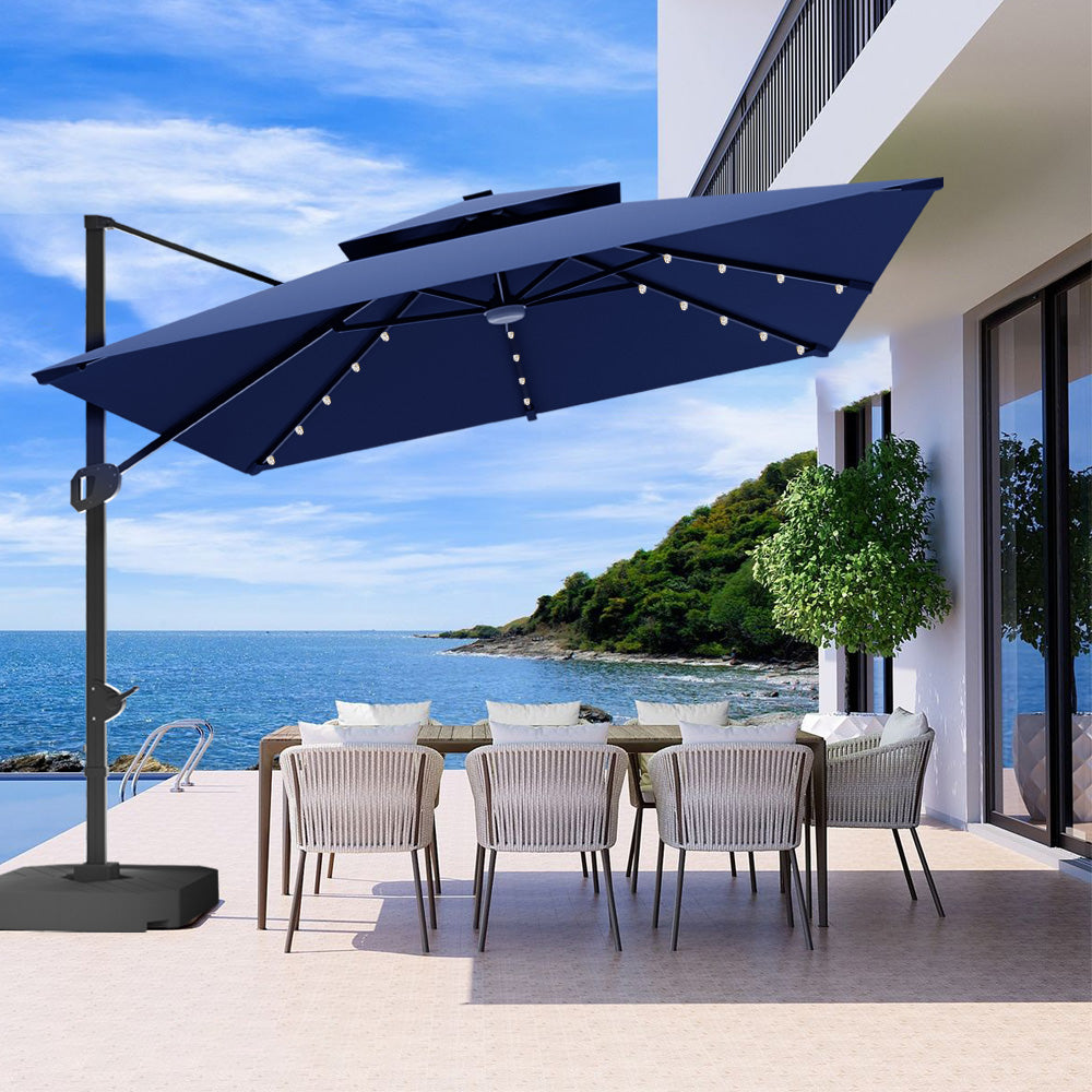 Patioslife 3x3m Navy Blue LED cantilever umbrella shading outdoor dining area by the sea