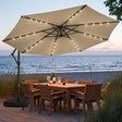 Patioslife Aegis Premium beige cantilever patio umbrella with solar LED lights over outdoor dining set by the beach