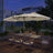 Patioslife Horizon Haven double-sided patio umbrella with base in cream, 4.6 x 2.7m, with LED lights over an outdoor dining set at night