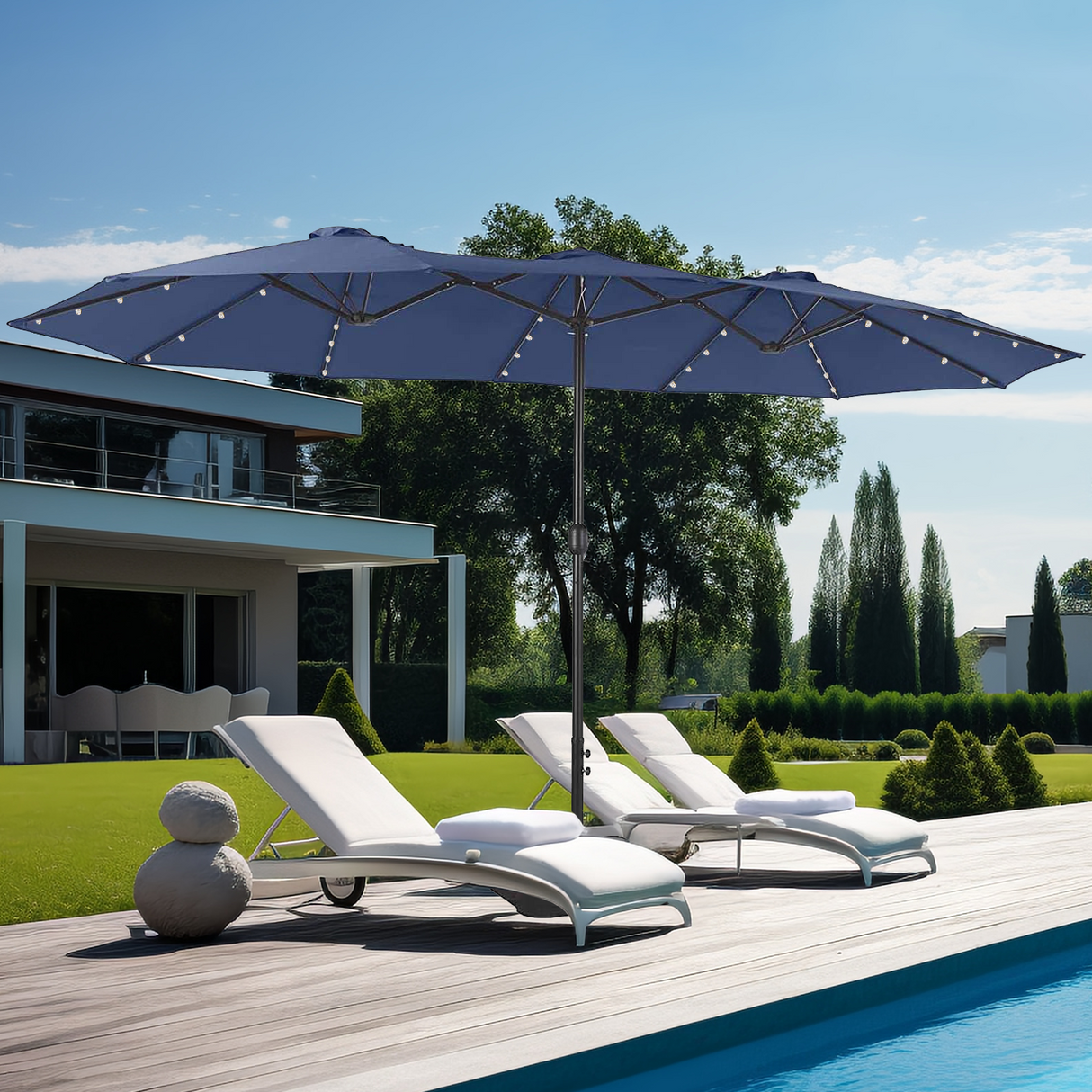 Patioslife Horizon Haven double-sided patio umbrella with base in navy blue, 4.6 x 2.7m, with LED lightsover pool loungers in a landscaped backyard
