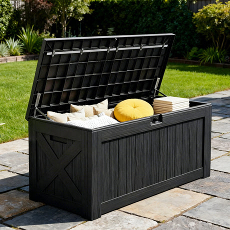 Large outdoor deck box with open lid storing pillows and cushions on patio, lockable black resin storage box