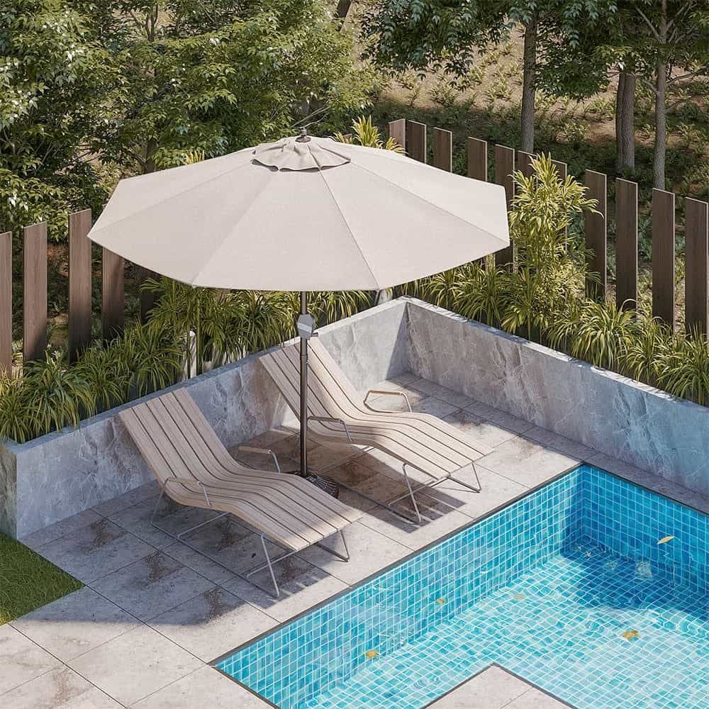 Patioslife Solara cream market umbrella over two sun loungers beside a private courtyard swimming pool