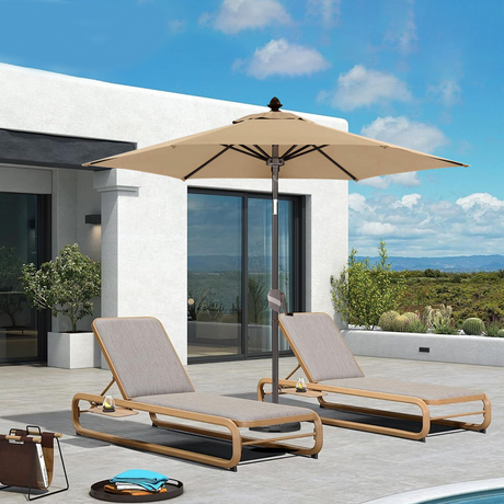 Patioslife Solara cream market umbrella shading two loungers on a modern villa patio with open sky view