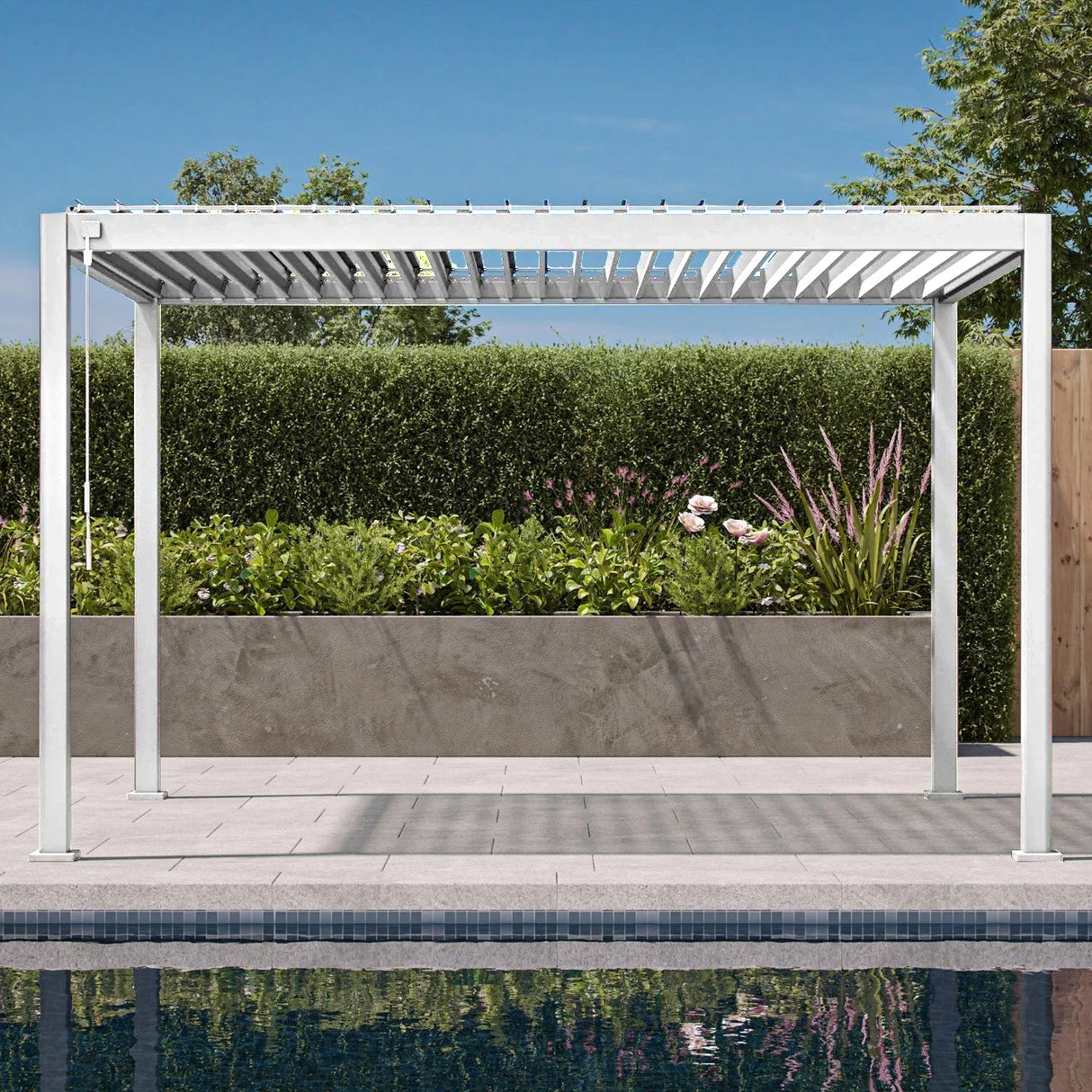 Patioslife 3 x 4m white heavy-duty aluminium louvered pergola beside a swimming pool and garden hedge