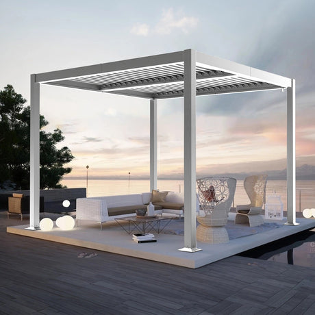 Patioslife 3 x 3m white aluminium pergola with adjustable louvers over a luxury outdoor lounge on a seaside deck at sunset